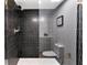 Modern bathroom with a stand-up shower featuring unique black and gray tiling at 1109 Brownshire Ct, Longwood, FL 32779