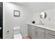 Chic bathroom featuring gray vanity with gold hardware, with toilet and framed print at 1109 Brownshire Ct, Longwood, FL 32779