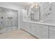 Modern bathroom featuring marble wall tiles, stylish vanity, and glass enclosed shower at 1109 Brownshire Ct, Longwood, FL 32779