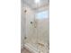 Bathroom with a glass shower door, marble tiles, and gold trim at 1109 Brownshire Ct, Longwood, FL 32779