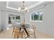 Dining area features modern lighting fixture, floor to ceiling window, and backyard access at 1109 Brownshire Ct, Longwood, FL 32779