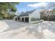 Modern home exterior with a gray tile roof, white walls, and a concrete driveway at 1109 Brownshire Ct, Longwood, FL 32779