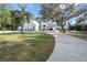 Expansive front yard showcasing a beautifully landscaped lawn and concrete driveway at 1109 Brownshire Ct, Longwood, FL 32779