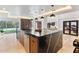 Kitchen island featuring black marble countertop, wine rack, and stainless steel dishwasher at 1109 Brownshire Ct, Longwood, FL 32779