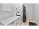 Laundry room with marble countertops, sink, modern faucet, and stackable washer and dryer at 1109 Brownshire Ct, Longwood, FL 32779