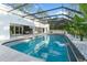 Aerial view of a screened-in pool area with lush foliage and an attached patio at 1109 Brownshire Ct, Longwood, FL 32779