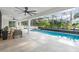 Outdoor space with a large screened pool, covered patio, and lush landscaping at 1109 Brownshire Ct, Longwood, FL 32779