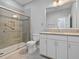 Bright bathroom featuring a glass-enclosed shower and white vanity with granite countertops at 1132 Fins Up Ct, Daytona Beach, FL 32124