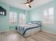 Bedroom with hardwood-style floors, two windows, a ceiling fan and light blue walls at 1132 Fins Up Ct, Daytona Beach, FL 32124