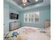 Cozy bedroom with a decorative ceiling, plantation shutters and soothing color palette at 1132 Fins Up Ct, Daytona Beach, FL 32124