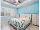 Comfortable bedroom with large window, tray ceiling, and coastal-themed decor at 1132 Fins Up Ct, Daytona Beach, FL 32124