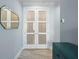 Bright hallway featuring white doors with frosted glass, a decorative mirror, and light wood-look flooring at 1132 Fins Up Ct, Daytona Beach, FL 32124