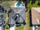 Aerial view of a well-maintained home with a private pool, lush landscaping, and a spacious backyard at 1165 Cardinal Creek Pl, Oviedo, FL 32765