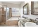 Bathroom featuring a shower over tub, double vanity with granite countertop, and decorative mirrors at 1165 Cardinal Creek Pl, Oviedo, FL 32765