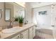 Well-lit bathroom with double sinks, white cabinets, and a tub/shower combination at 1165 Cardinal Creek Pl, Oviedo, FL 32765