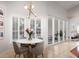 Bright dining area with a modern light fixture, white shutters, and views of the yard at 1165 Cardinal Creek Pl, Oviedo, FL 32765