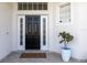 Elegant front door with sidelights, transom window, and a welcoming 'Come In' doormat at 1165 Cardinal Creek Pl, Oviedo, FL 32765