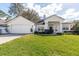 Charming single-story home with a well-manicured lawn, attached garage, and white stucco exterior at 1165 Cardinal Creek Pl, Oviedo, FL 32765