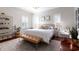 Bright main bedroom featuring a large bed, hardwood floors, and plantation shutters at 1165 Cardinal Creek Pl, Oviedo, FL 32765