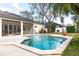 Inviting backyard pool with screened-in lanai, lush landscaping, and a patio area for outdoor entertaining at 1165 Cardinal Creek Pl, Oviedo, FL 32765