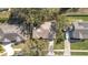 Top-down aerial view of a house with a boat, driveway, mature trees and manicured lawn at 1224 Shorecrest Cir, Clermont, FL 34711