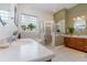 Inviting bathroom with a glass block window, step-in shower, and a double sink vanity at 1224 Shorecrest Cir, Clermont, FL 34711