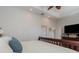 Bright bedroom showcasing recessed lighting, en-suite bathroom, and modern entertainment setup at 1224 Shorecrest Cir, Clermont, FL 34711