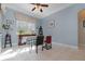 Cozy dining room with a ceiling fan and a table set for four, bathed in natural light at 1224 Shorecrest Cir, Clermont, FL 34711