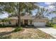 Charming single-story home with manicured landscaping, attached two-car garage, and inviting front entrance at 1224 Shorecrest Cir, Clermont, FL 34711