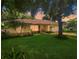 Charming single-story home boasts a lush landscaped yard with mature trees and a cozy, inviting facade at 1224 Shorecrest Cir, Clermont, FL 34711