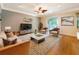 Well-lit living room features hardwood floors, neutral tones, and comfortable seating arrangements at 1224 Shorecrest Cir, Clermont, FL 34711