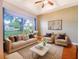 Bright and airy living room featuring neutral tones, a large window, and stylish, comfortable seating at 1224 Shorecrest Cir, Clermont, FL 34711