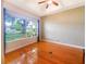 Bright and airy living room with hardwood floors and large window overlooking the outdoors at 1224 Shorecrest Cir, Clermont, FL 34711
