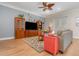 Bright living room with a wood-look floors, ceiling fan, neutral gray sofa, and stylish decor at 1224 Shorecrest Cir, Clermont, FL 34711