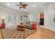 Open-concept living area with wood-look floors, a gray sofa, and a view into the kitchen at 1224 Shorecrest Cir, Clermont, FL 34711