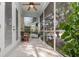 Enclosed patio featuring tile flooring, a ceiling fan, and lush greenery surrounding the screened-in enclosure at 1224 Shorecrest Cir, Clermont, FL 34711