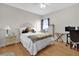 Bright bedroom with hardwood floors, a white ceiling fan and a comfy bed at 1246 Pallister Ln, Lake Mary, FL 32746