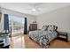 Bright bedroom with a large window, hardwood floors, and a black and white patterned bedspread at 1246 Pallister Ln, Lake Mary, FL 32746