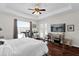 Bright bedroom with hardwood floors, trey ceilings, access to the pool and a TV at 1246 Pallister Ln, Lake Mary, FL 32746