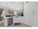 Open concept kitchen with white cabinets, stainless appliances, a countertop with an eating area, and views of the living room at 1246 Pallister Ln, Lake Mary, FL 32746