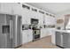 Modern kitchen with stainless steel appliances, abundant white cabinetry, and tile floors at 1246 Pallister Ln, Lake Mary, FL 32746