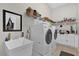 Convenient laundry room with a sink, storage shelves, and washer/dryer at 1246 Pallister Ln, Lake Mary, FL 32746