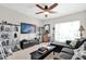 Comfortable living room with a ceiling fan, large TV, and unique decor at 1246 Pallister Ln, Lake Mary, FL 32746