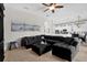 Comfortable living room with a large sectional sofa, tile flooring, and an open view to the spacious kitchen at 1246 Pallister Ln, Lake Mary, FL 32746
