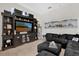 Comfortable living room featuring a large entertainment center and a sectional sofa with ottoman at 1246 Pallister Ln, Lake Mary, FL 32746