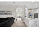 Open floorplan showing the living room leading to the kitchen with tile flooring, neutral walls, and modern decor at 1246 Pallister Ln, Lake Mary, FL 32746