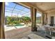 Covered patio offers an outdoor dining area and serene views of the pool at 1246 Pallister Ln, Lake Mary, FL 32746