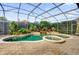 Enjoy this screened pool featuring a waterfall, jacuzzi and lush landscaping at 1246 Pallister Ln, Lake Mary, FL 32746