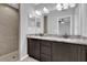 Bathroom features a double sink vanity with granite countertops and a tiled walk-in shower at 13258 Sw 29Th Cir, Ocala, FL 34473
