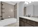 Neutral bathroom with a granite countertop vanity, and a bath tub with tile surround at 13258 Sw 29Th Cir, Ocala, FL 34473